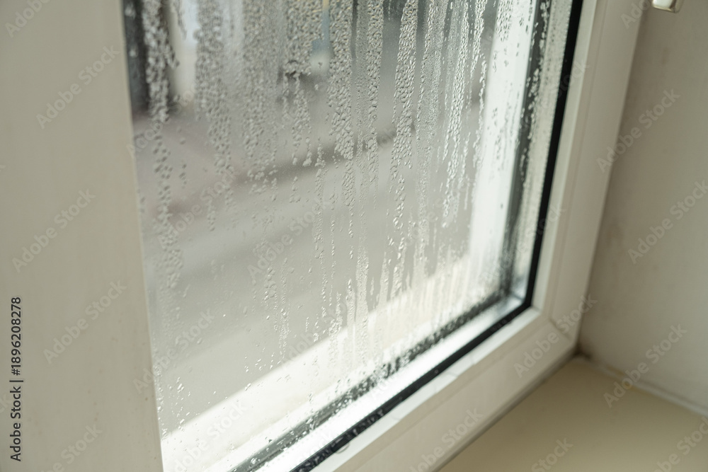 Fototapeta premium Close up of misted window glass with water streaks and droplets