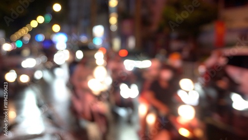 Asia, Vietnam , Ho Chi Minh,  blurred lights of city traffic . Congested traffic of cars and scooters on the streets of Saigon night  - Air pollution PM10 and fine particles above the permitted thresh