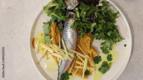 Fish served with greens, apple, and mashed potatoes.