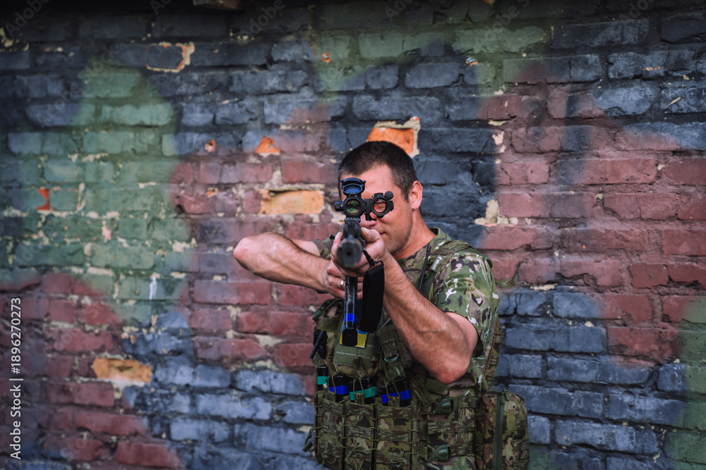 Fototapeta premium Ukrainian soldier aiming rifle during war against invasion