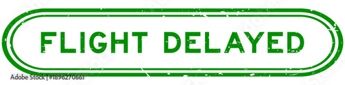 Grunge green flight delayed word rubber seal stamp on white background
