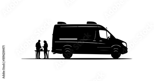 Black Silhouette of Two People Loading Cargo into a Van