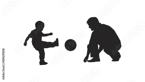 Father and son playing soccer silhouette