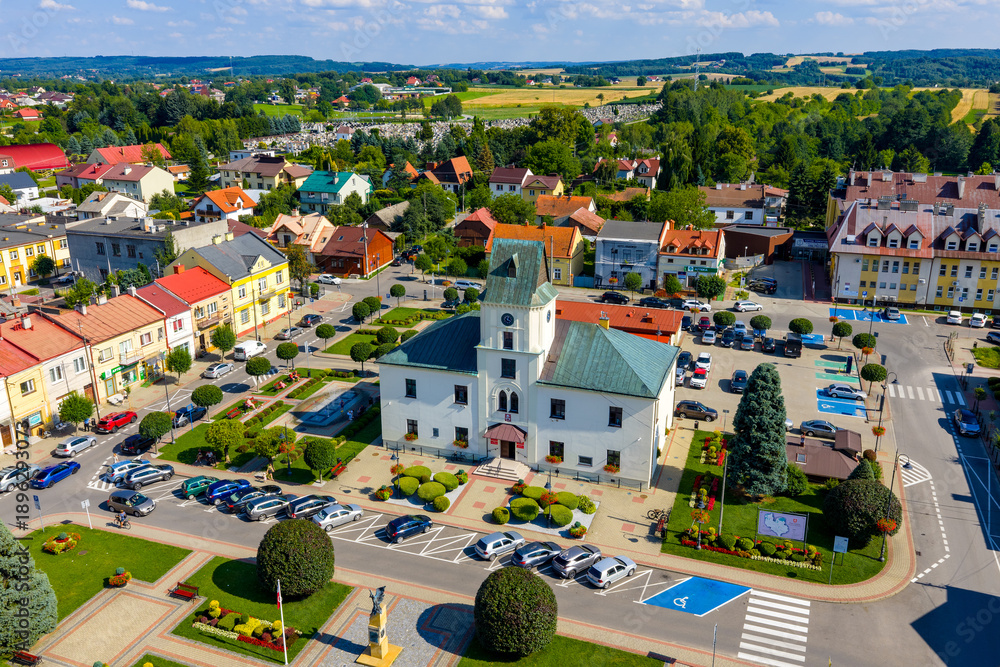 Fototapeta premium Aerial view of old town center with historic Ratusz Town Hall at Rynek market square of Sedziszow Malopolski town in Podkarpacie region of Lesser Poland