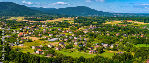 Aerial panoramic view of disperse housing of residential district of Andrychow city with Beskidy Mountains in background in Lesser Poland