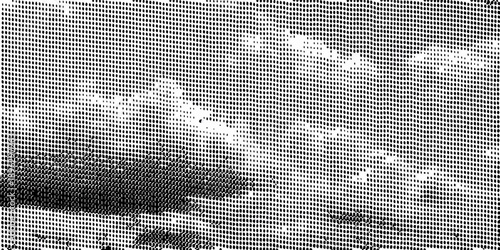 Abstract grayscale image depicting cloud formations through a patterned screen
