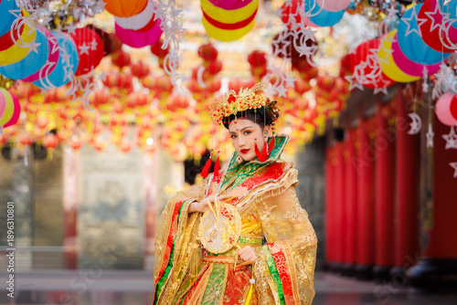 Fotografija An elegant woman in a traditional Chinese costume poses under vibrant lanterns d