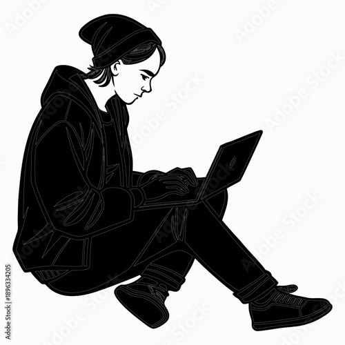 Young man sitting on floor using laptop computer with concentration and focus in a casual setting from a side view