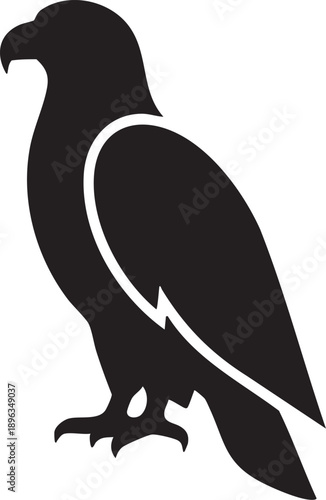 Black silhouette of a bird of prey standing alone