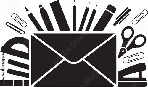 Black and white envelope surrounded by office supplies