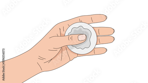 Hand holding a round object with a textured surface