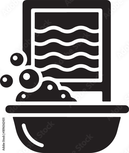 Old laundry washboard with soap suds and basin for traditional clothes cleaning methods and domestic household chores in vintage retro style