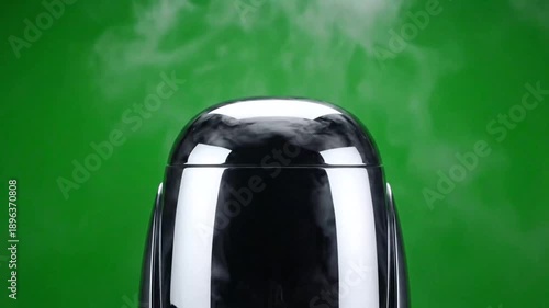 Abstract vapor rising from a glass against green background studio shot