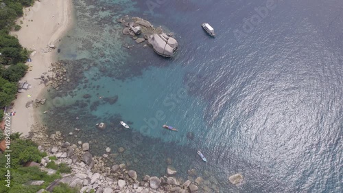 Serene Coastal Scenery, Idyllic Seaside Location Featuring Anchored Vessel And Vibrant Coral Reefs