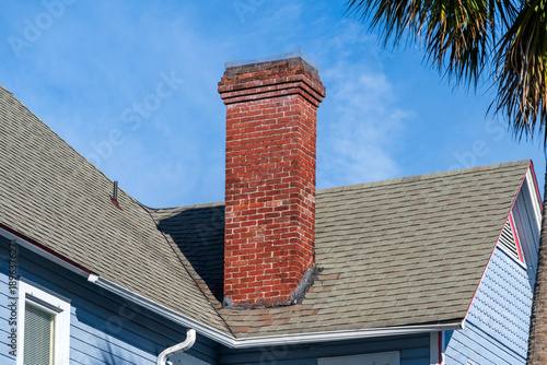 An old red brick chimney on a Florida house