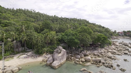 Scenic Island Seascape, Drone Captures Tranquil Shoreline With Boats And Vibrant Nature Surroundings