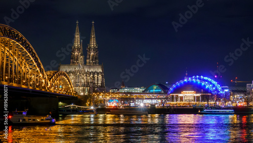 Cologne city skyline panorama at night, Rhine river with illuminated Cologne Cathedral, Great St. Martin Church and Hohenzollern Bridge, Germany