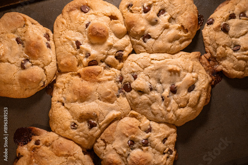 Top down view of chocolate chip cookies that have melted together on the baking sheet.  Common baking mistake concept.