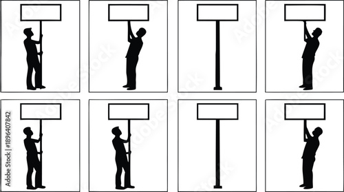Silhouette of a man holding and installing a billboard