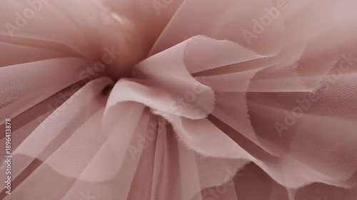 Delicate Dusty Rose Tulle Fabric Textures and Folds Close-Up Creating Abstract Background