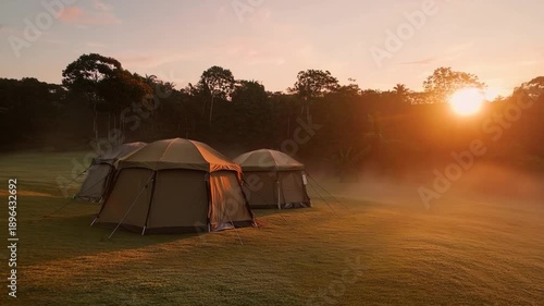 Wallpaper Mural Magical Camping: Tents nestled in a misty meadow, bathed in the warm glow of sunrise Torontodigital.ca
