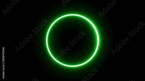 A luminous neon green ring against a dark backdrop, creating a stark visual contrast. The bright, circular shape draws the eye, suggesting themes of energy and modern design.