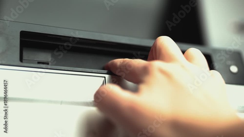 Close up of a hand holding a videotape. Retro vhs cassete in a player.	