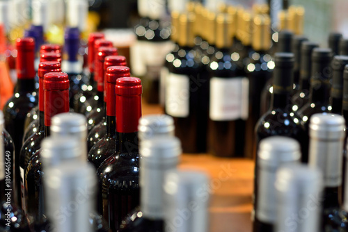 Rows of Red and White Wine Bottles on Display in a Store