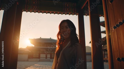 Beauty of the East: A radiant woman smiles, illuminated by the warm light of sunrise as she stands framed by an ancient archway, representing history and tradition. 