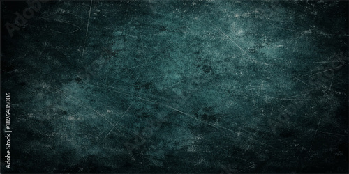 A dark blue grunge texture features an old aged paper pattern with a dirty rough concrete surface and black chalkboard elements for a vintage grungy wall backdrop