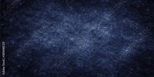 A dark blue grunge background with a textured vintage wall pattern and black paint material provides a blank old paper backdrop for your design