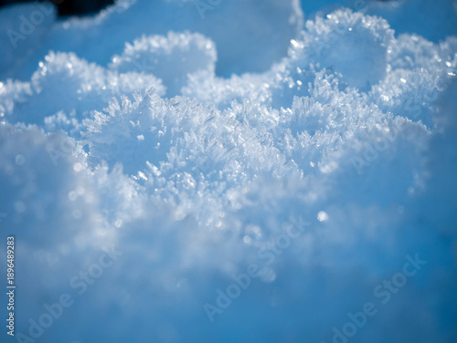 Delicate Ice Crystals Reflect Luminous Blue Light In Serene Winter Landscape Filled With Wonder