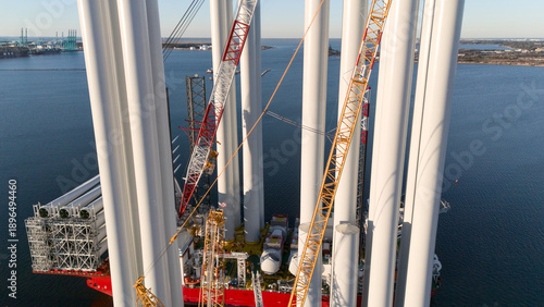 Cuadro en lienzo Drone view of wind turbine towers and heavy cranes on offshore vessel at port