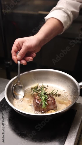 The chef prepares a Wellington steak in the kitchen.