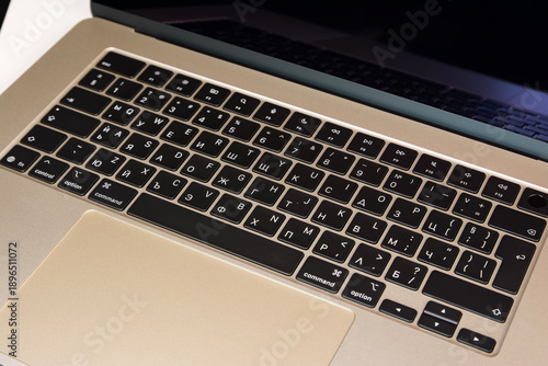 Closeup view of a laptop keyboard featuring Cyrillic characters, highlighting technology and typography details