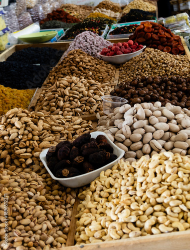 Various types of nuts—pecans, almonds, pistachios, and cashews—on display at a market stall, Chorsu Bazaar, Tashkent, Uzbekistan