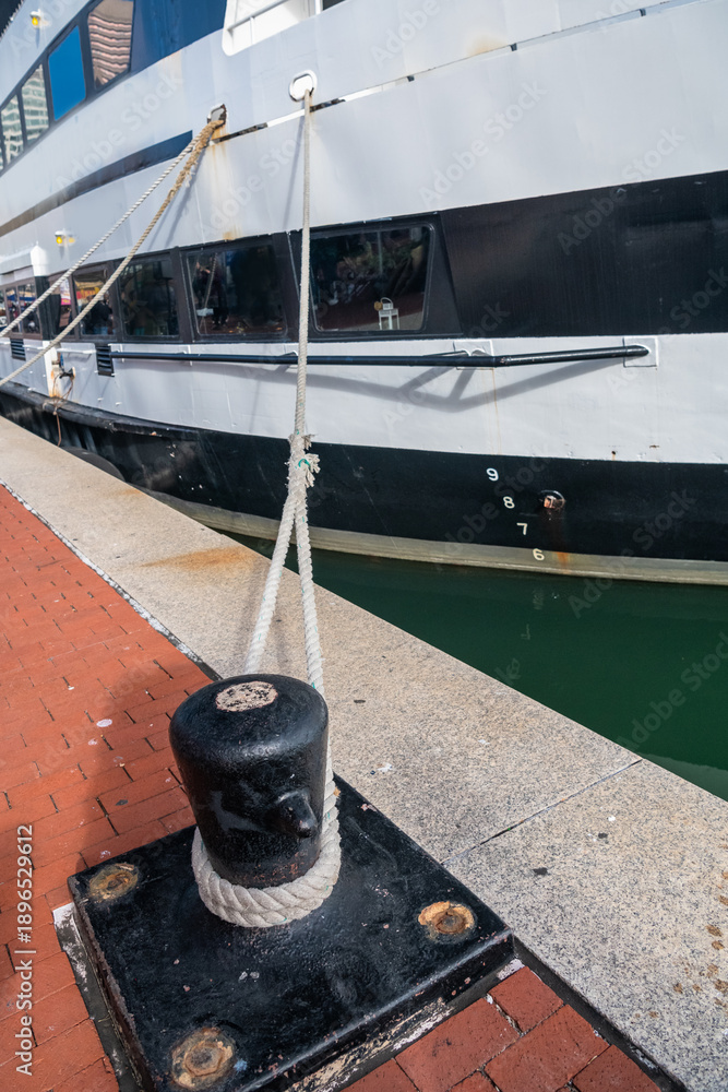 Fototapeta premium Mooring bollard with rope and moored vessel