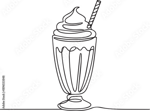 A milkshake with whipped cream and striped straw in a tall glass