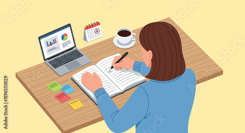 Woman writing notes in a notebook at her desk with a laptop and coffee.