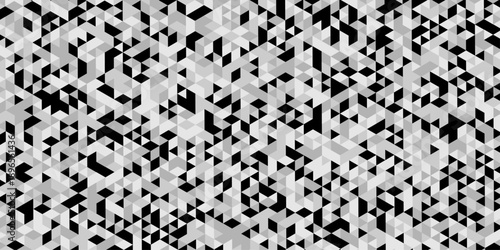 Abstract geometric pattern composed of interlocking triangles shapes, rendered in a monochrome black, white, and gray palette, the design features sharp angles modern, minimalist background.