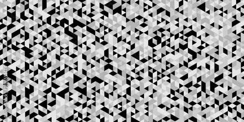 Abstract geometric pattern composed of interlocking triangles shapes, rendered in a monochrome black, white, and gray palette, the design features sharp angles modern, minimalist background.
