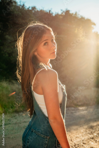 Profile portrait of a teenage girl in sunlight