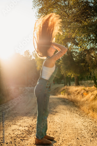girl tossing hair in sunlight
