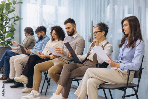 Quadro em tela Diverse group of job candidates waiting for interviews in an office reception ar