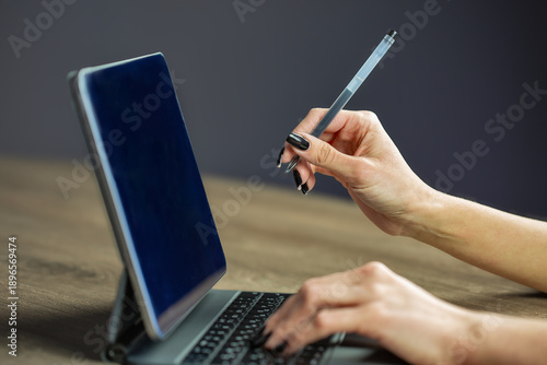 Woman using stylus pen with digital tablet computer closeup