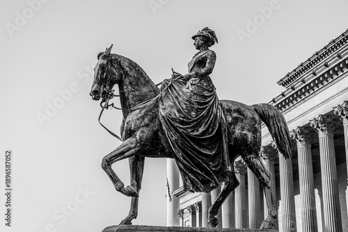 Liverpool, Lancashire, UK: Equestrian statue of Queen Victoria, 1870 statue of a young Queen Victoria outside St George's Hall
and opposite Lime Street Station in black and white