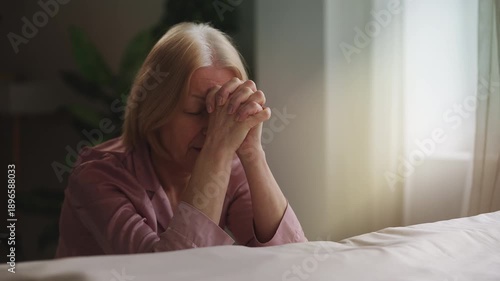 Wallpaper Mural Senior woman putting hands together in prayer, asking God for health and mercy Torontodigital.ca