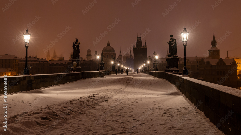 Obraz premium Winter morning with lit gas lamps on the snowy Charles Bridge