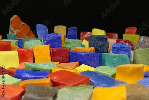 Multi-colored smalt from old Soviet mosaics on black background