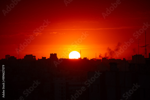 sunset after a hot summer day over the rooftops of Buenos Aires, Argentina, symbol for global warming and heat